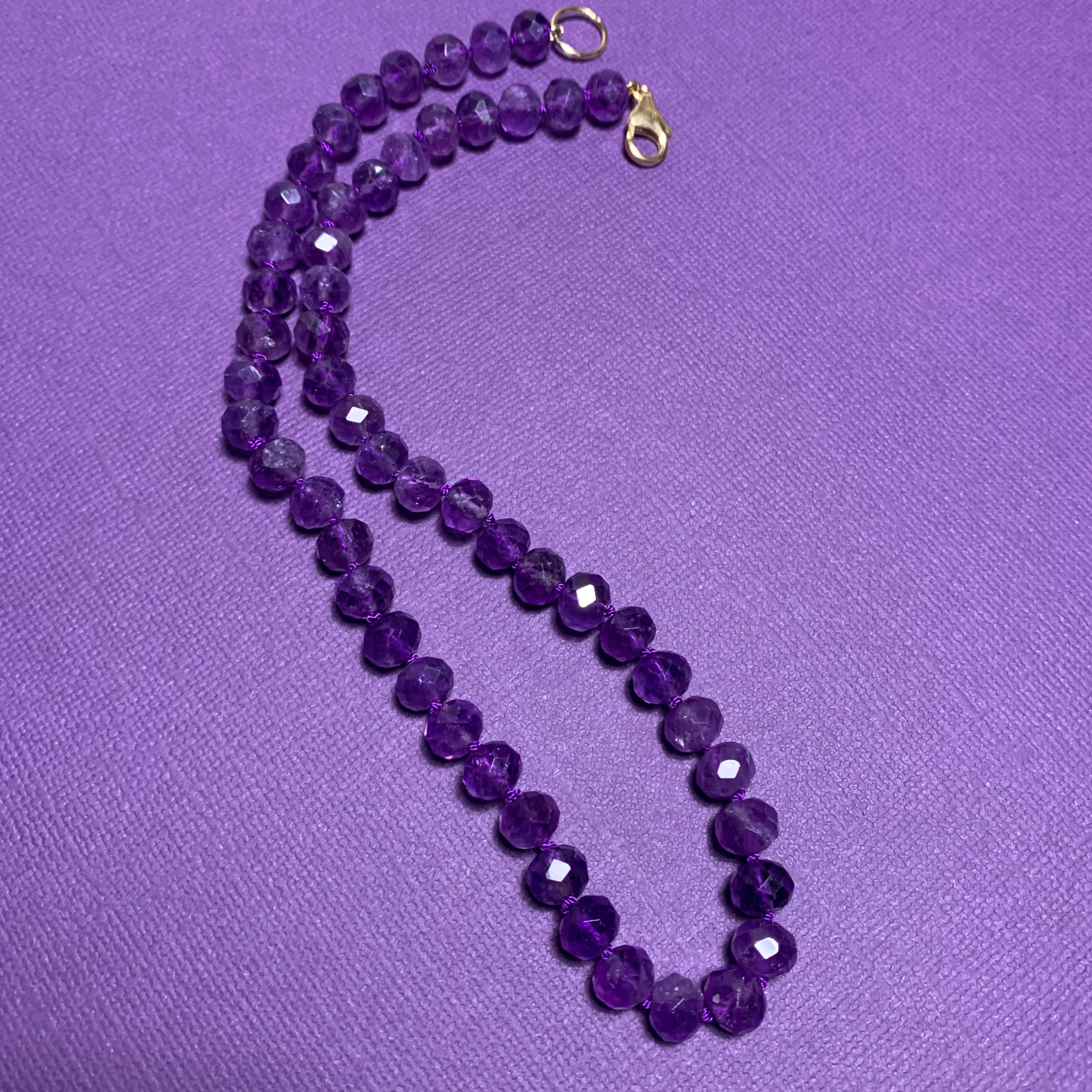 Chinese export amethyst bead store necklace. Knotted strand of glowing knuckle beads with gilt silver clasp.